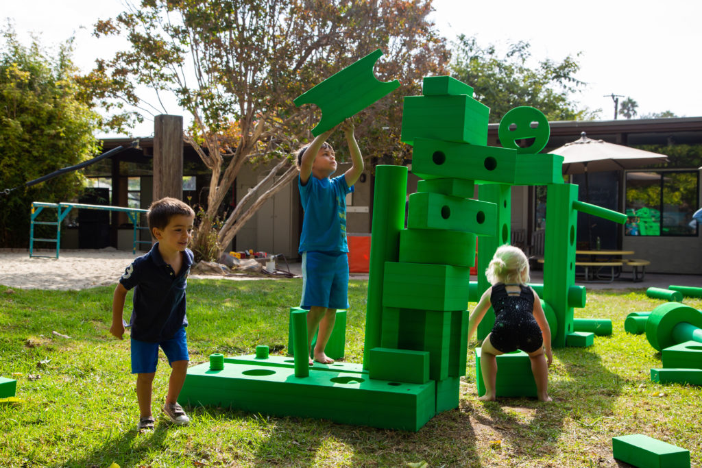 kids playing with bright day big blocks